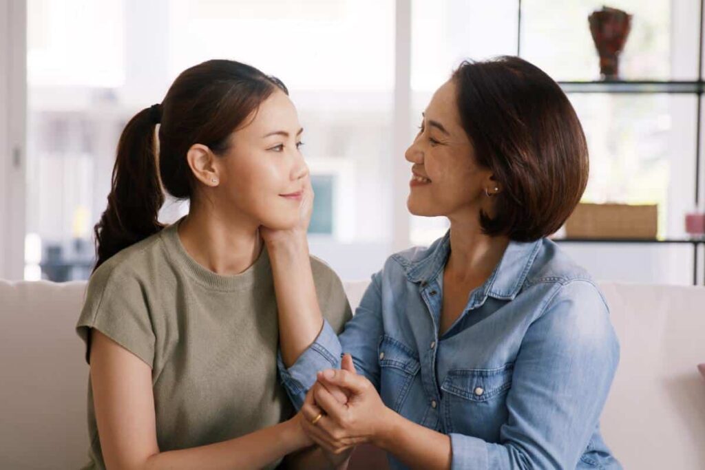 a parent comforts a teen awho is smiling after realizing motivational enhancement therapy benefits