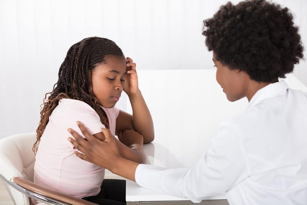 a therapist works with a child on how to deal with anxiety crisis