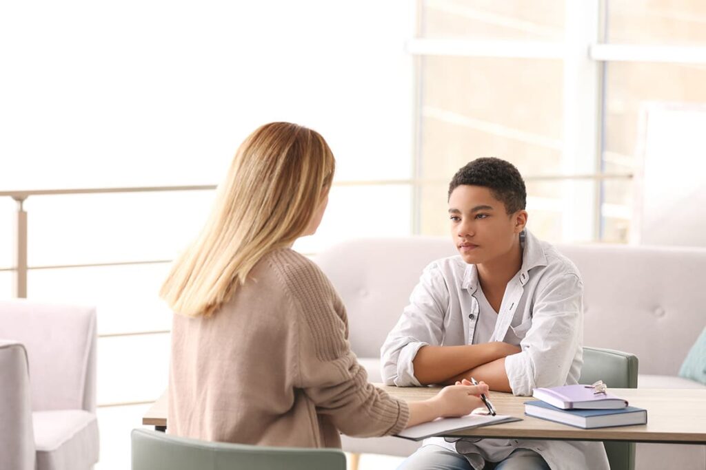 a teen talks to a therapist during Teen Anxiety Treatment