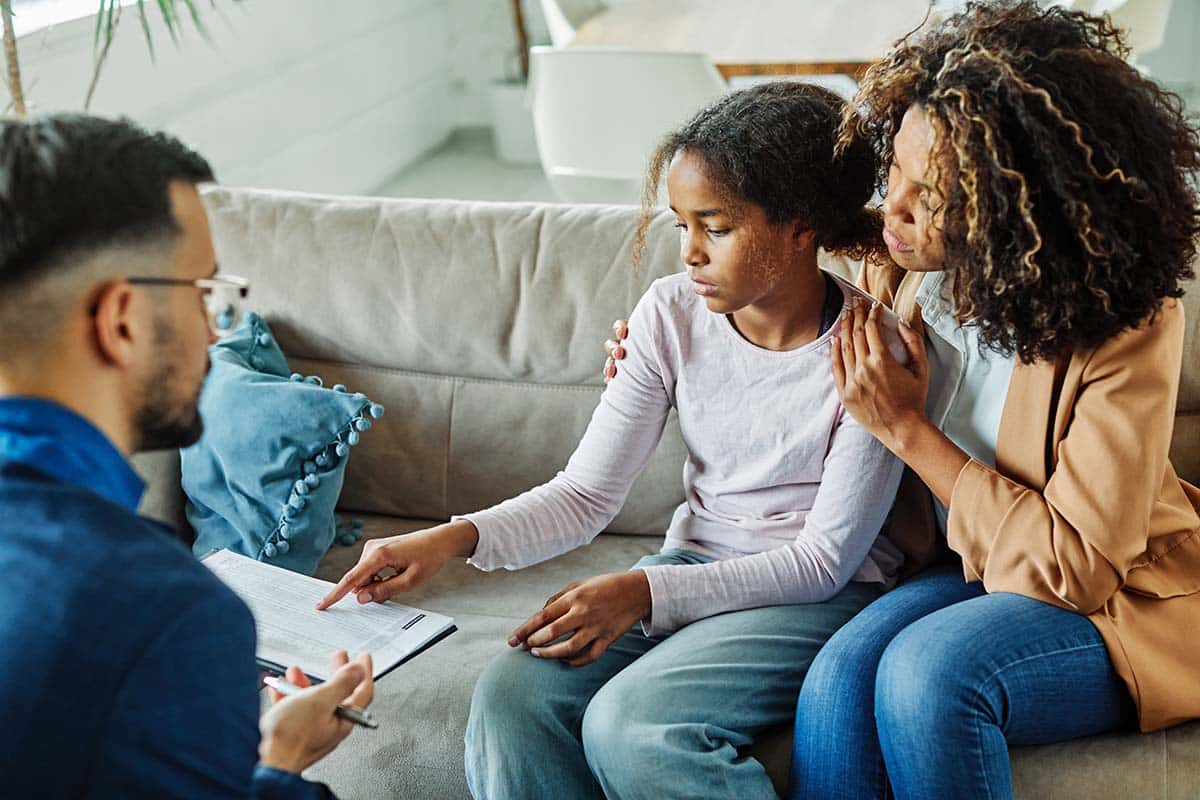 a mother and child talk to a therapist during partial hospitalization for teens