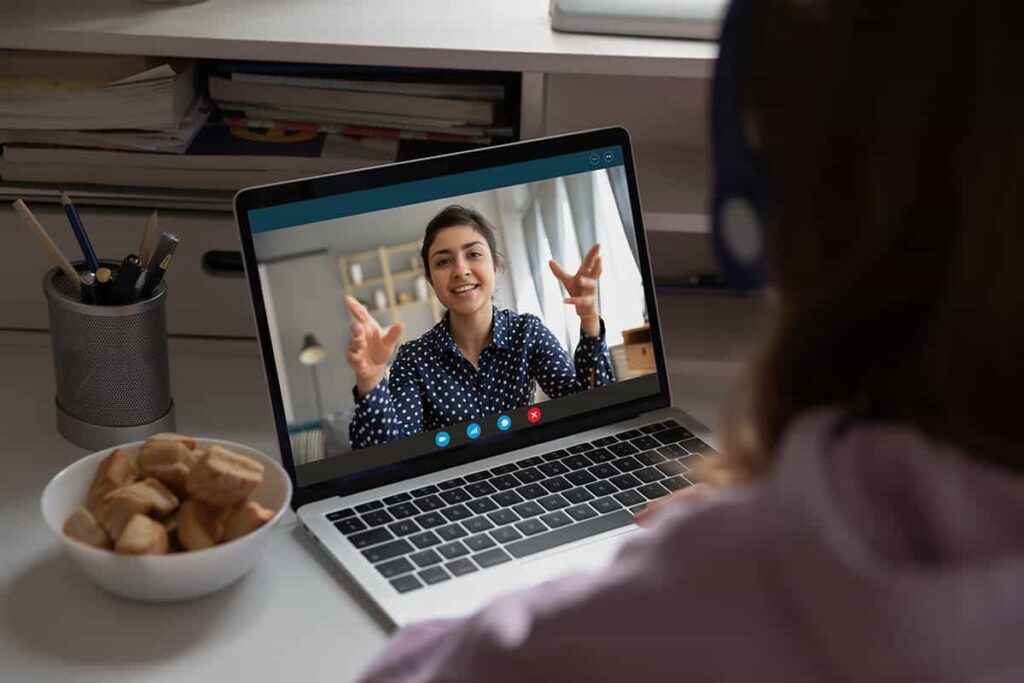 a therapist talks to a teen on a video call during Telehealth Services