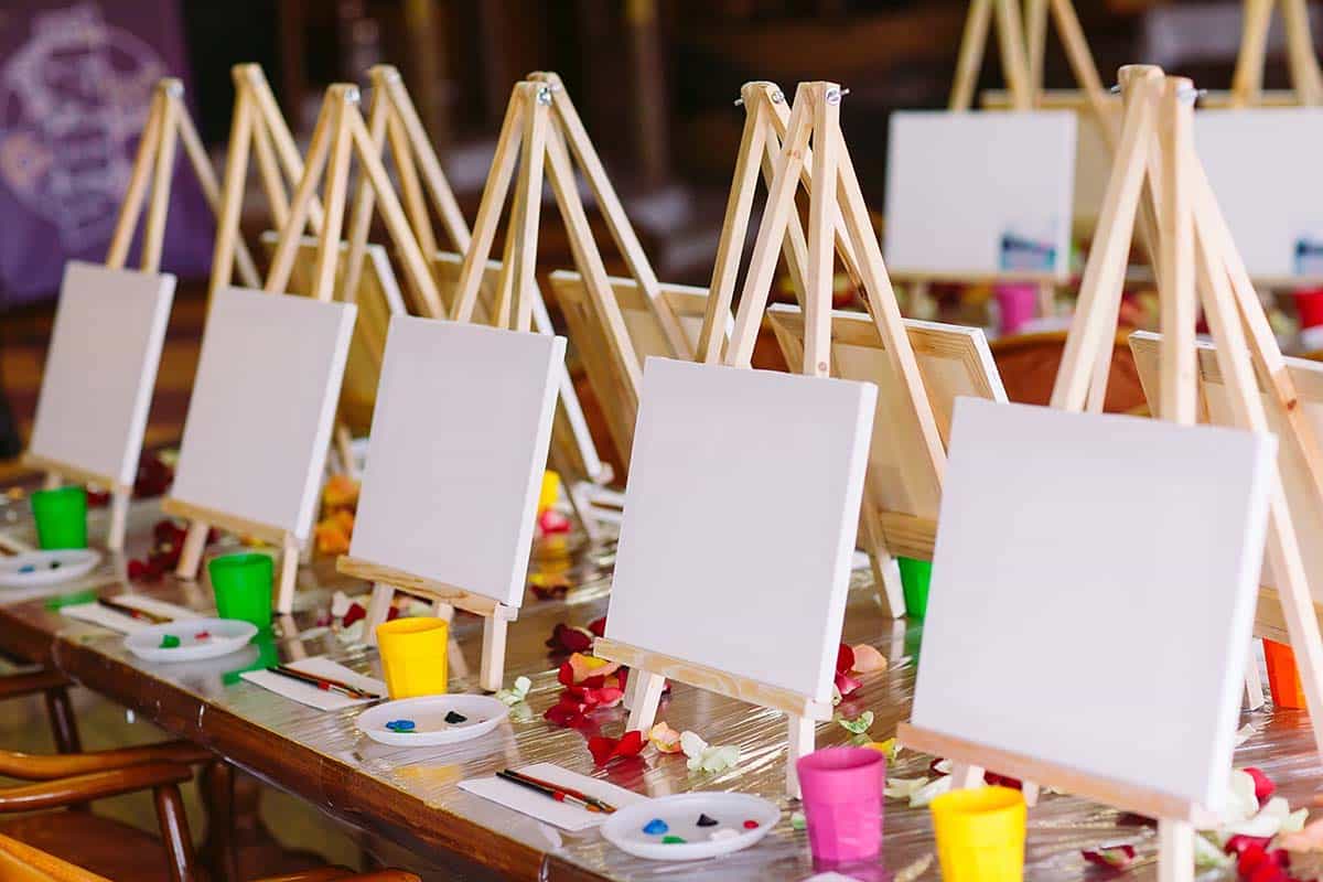 two rows of easels and painting supplies that can help teens realize the benefits of art therapy