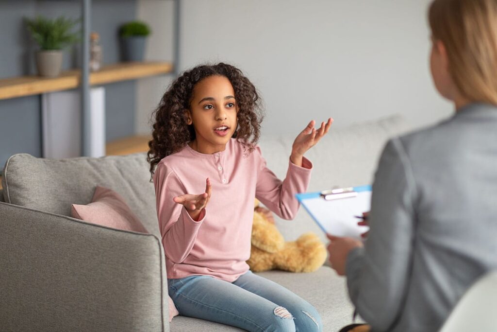 a teen talks to a therapist during teen counseling