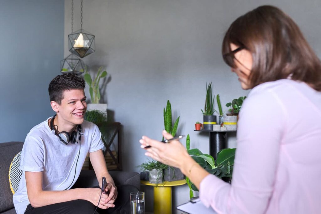 a psychologist conducts a teen mental health assessment with a client