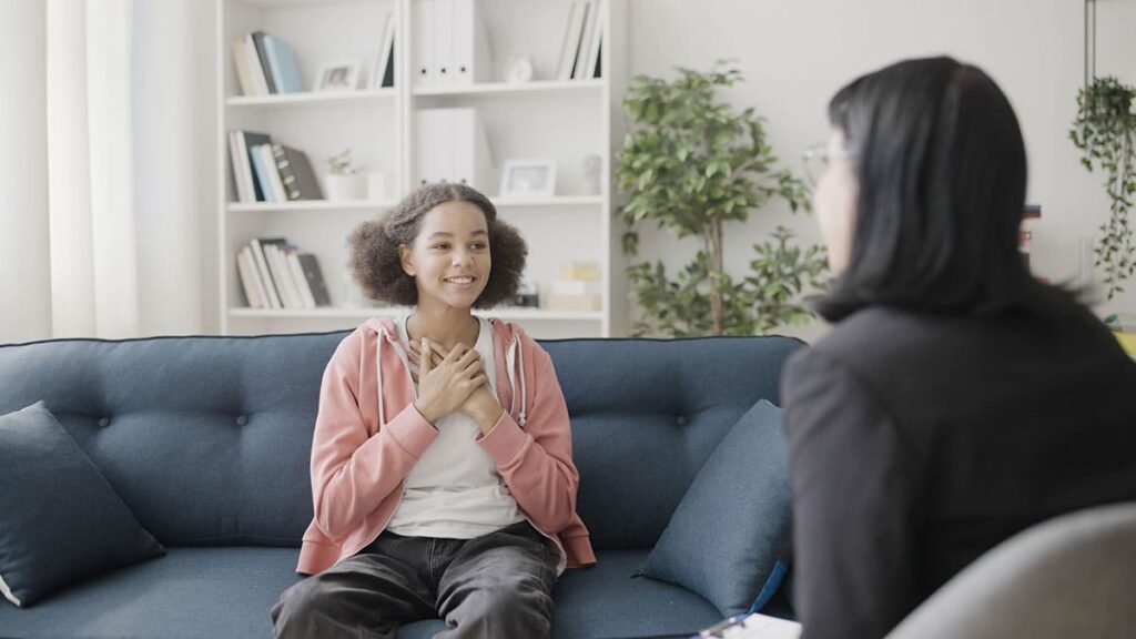 a young person talks to a therapist during adolescent day treatment