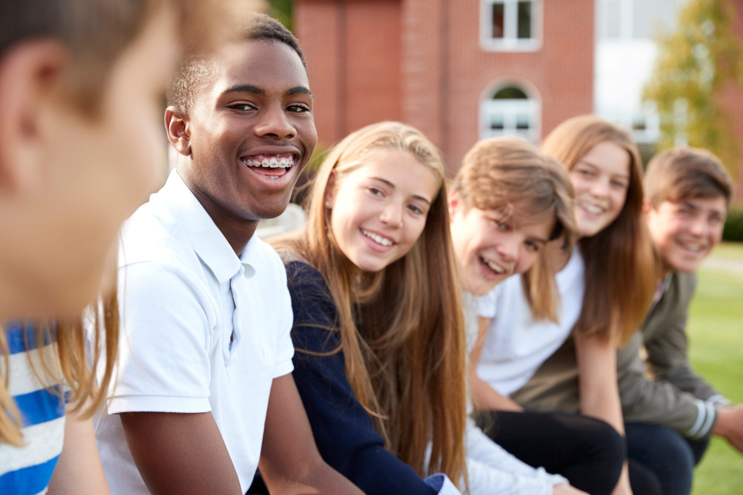 teens laughing together outside